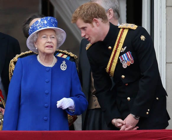 LONDON, ENGLAND - JUNE 15: Prince Harry chats to Queen Elizabeth II on the balcony of Buckingham Palace during the annual Trooping the Colour Ceremony on June 15, 2013 in London, England. Today&#039;s ...