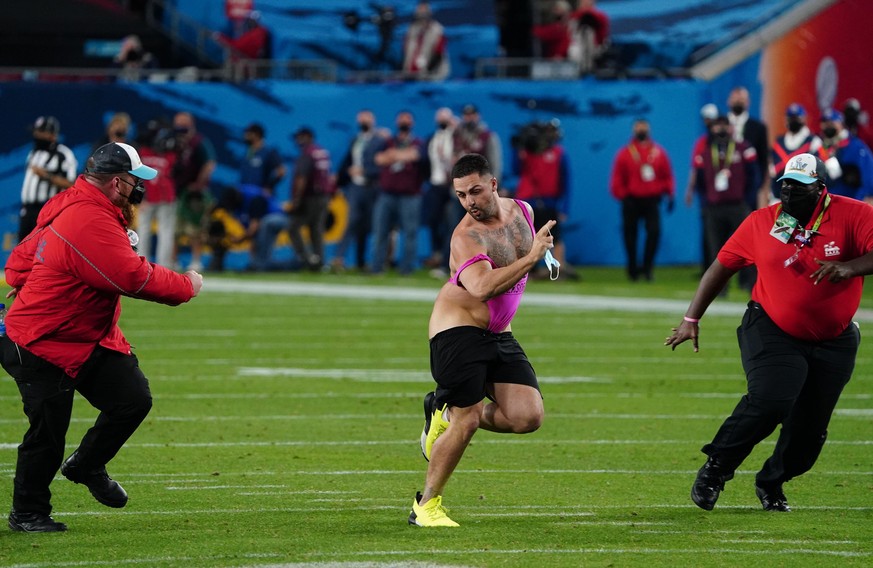 An unidentified man eludes security men after he ran onto the playing field in the fourth quarter of Super Bowl LV at Raymond James Stadium in Tampa, Florida on Sunday, February 7, 2021. Photo by Kevi ...