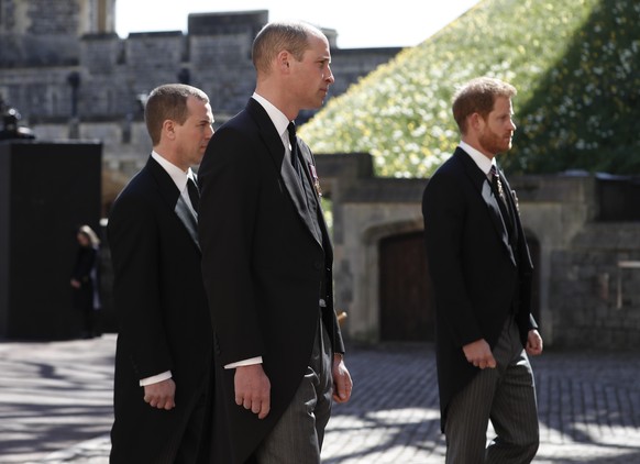 Britain&#039;s Prince Harry, right, Prince William, Peter Phillips, left, follow the coffin in a ceremonial procession for the funeral of Britain&#039;s Prince Philip inside Windsor Castle in Windsor, ...