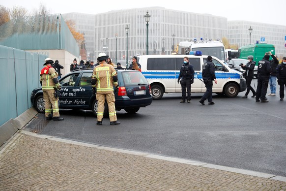 Firefighters remove the car which crashed into the gate of the main entrance of the chancellery in Berlin, the office of German Chancellor Angela Merkel in Berlin, Germany, November 25, 2020. REUTERS/ ...