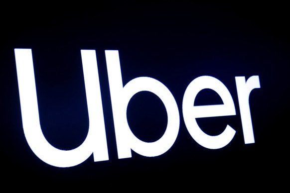 FILE PHOTO: A screen displays the company logo for Uber Technologies Inc. on the day of it&#039;s IPO at the New York Stock Exchange (NYSE) in New York, U.S., May 10, 2019. REUTERS/Brendan McDermid/Fi ...