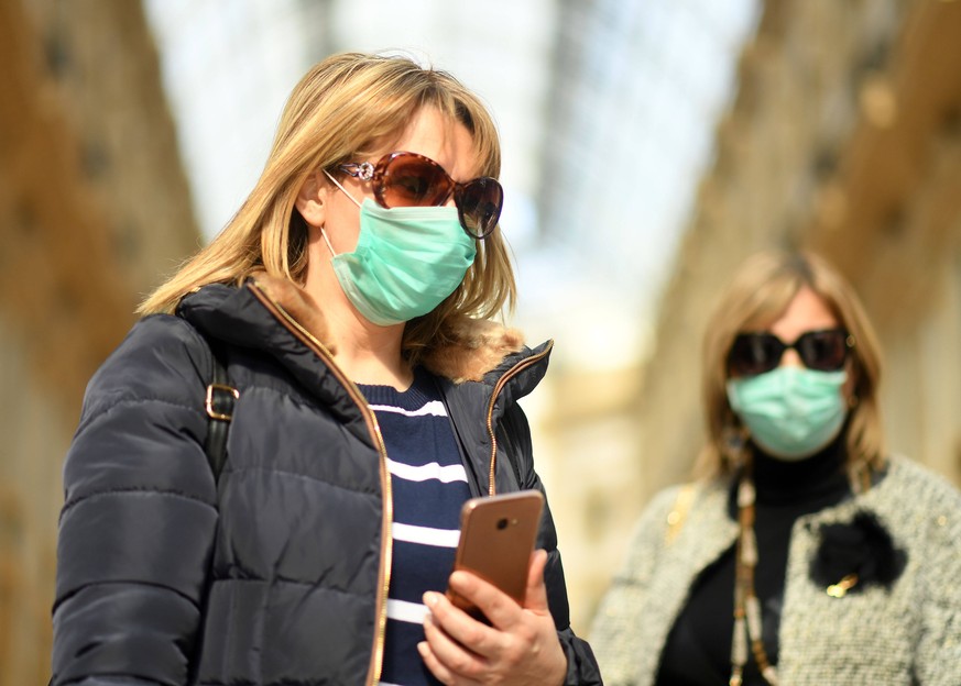 200224 -- MILAN, Feb. 24, 2020 Xinhua -- People wearing masks are seen in Milan, Italy, on Feb. 24, 2020. Six people have died and 222 have tested positive for the novel coronavirus COVID-19 nationwid ...