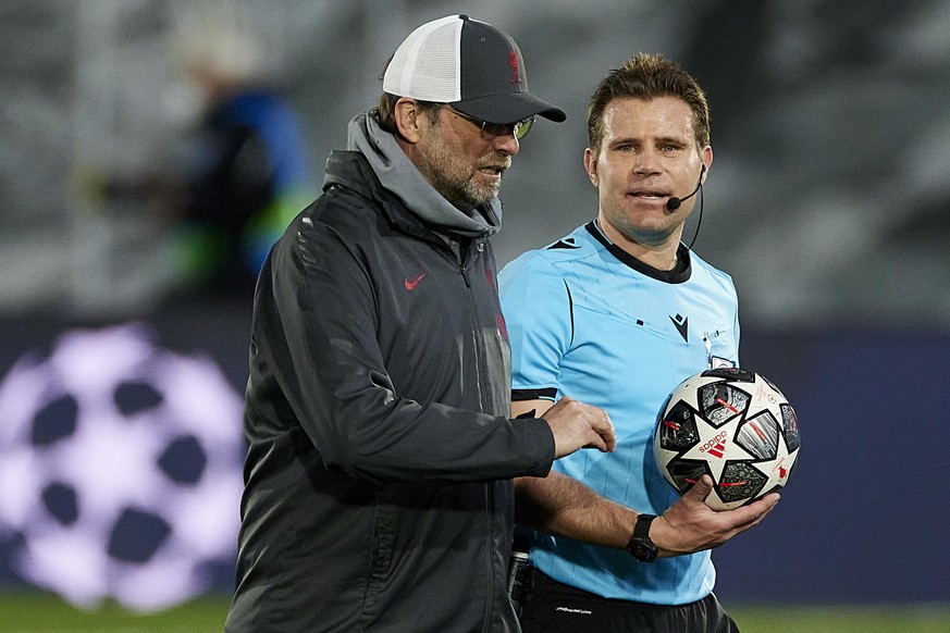 Liverpool FC coach Jurgen Klopp and referee Felix Brych during the Champions League match, 1/4 between Real Madrid and Liverpool played at Alfredo Di Stefano Stadium on April 6, 2021 in Madrid, Spain. ...
