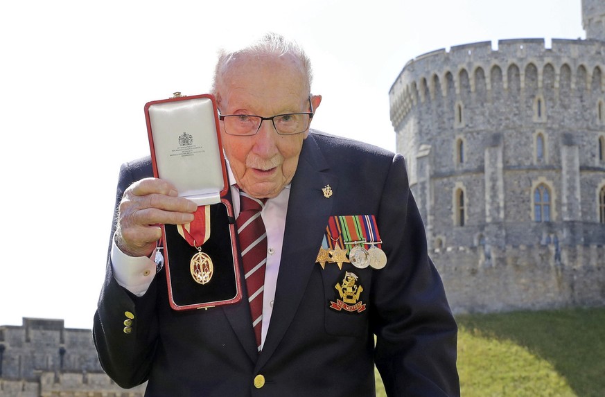 FILE - In this Friday, July 17, 2020 file photo, Captain Sir Thomas Moore poses for the media after receiving his knighthood from Britain&#039;s Queen Elizabeth, during a ceremony at Windsor Castle in ...