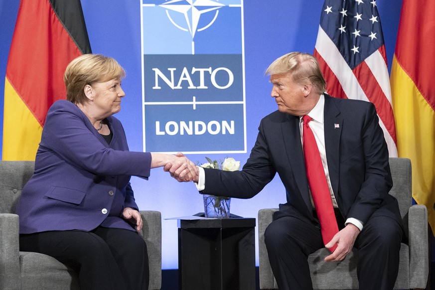 December 4, 2019, Watford, England, United Kingdom: U.S. President Donald Trump and German Chancellor Angela Merkel hold a bilateral meeting on the sidelines of the NATO Summit December 4, 2019 in Wat ...