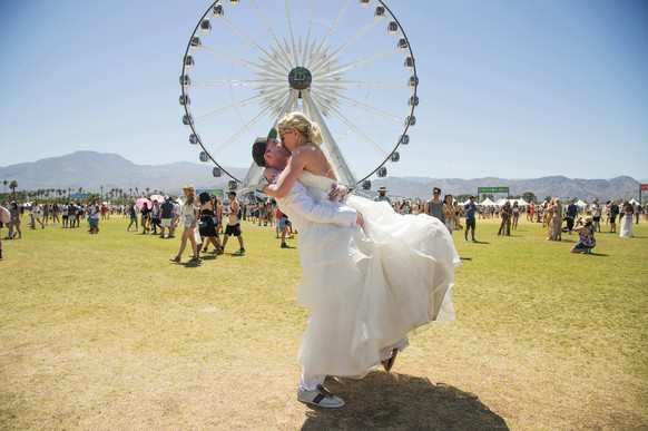 Ben Vaughn, left, and Ariel Vaughn, of Chicago, pose after their wedding at the Coachella Music &amp; Arts Festival at the Empire Polo Club on Friday, April 20, 2018, in Indio, Calif. (Photo by Amy Ha ...