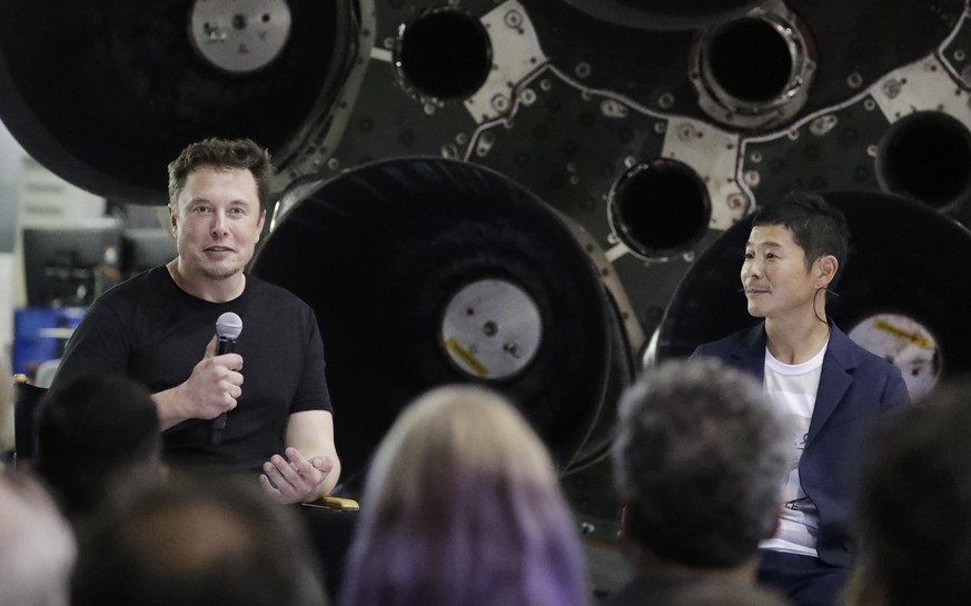 SpaceX founder and chief executive Elon Musk, left, announces Japanese billionaire Yusaku Maezawa, right, as the first private passenger on a trip around the moon, Monday, Sept. 17, 2018, in Hawthorne ...