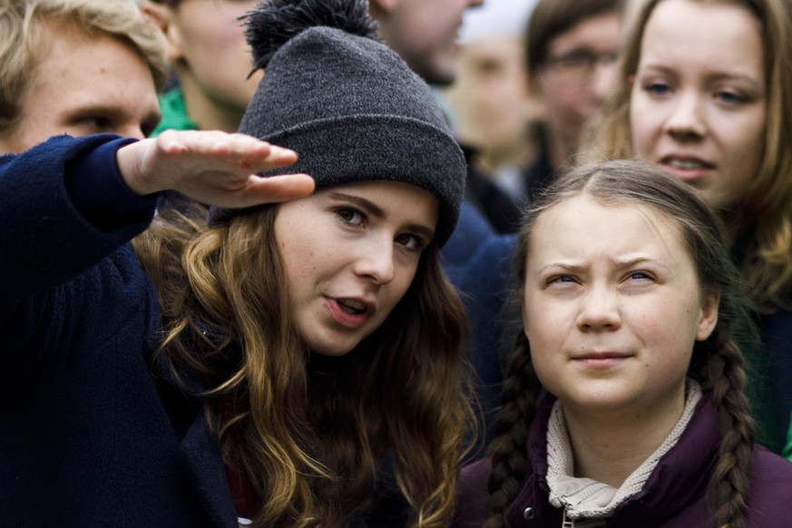 BERLIN, GERMANY - MARCH 29: Swedish teenage climate activist Greta Thunberg speaks with German climate activist Luisa Neubauer (L) as they participate in a Fridays for Future march on March 29, 2019 i ...
